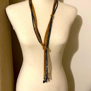 Necklace with royal  blue beads, that sparkle intertwined with tan suede.